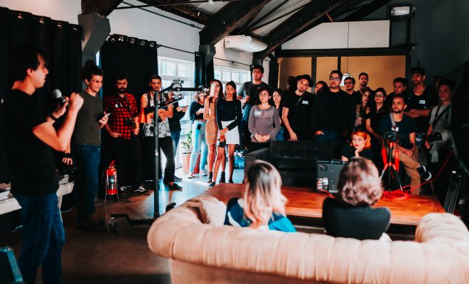 group of people standing inside room 2608517